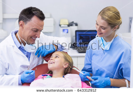 stock-photo-dentist-and-nurse-interacting-with-a-young-patient-in-clinic-643312912